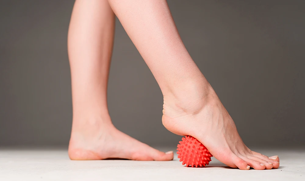 A 3D printed shoe with a honeycomb structure, bright yellow-green, with laces, lies on a machine or 3D printer.